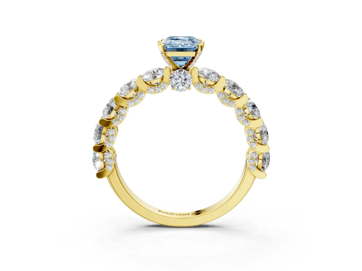 Fancy Blue Emerald Cut Diamond Side Stone Engagement Ring with Four-Prong Setting Yellow gold