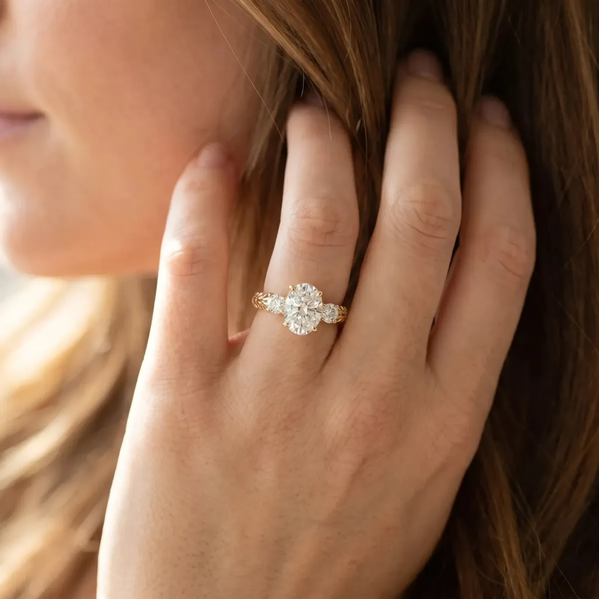 Three-Stone Oval Cut Cut Diamond Ring with Channel-Set Band and Prong Setting Yellow gold