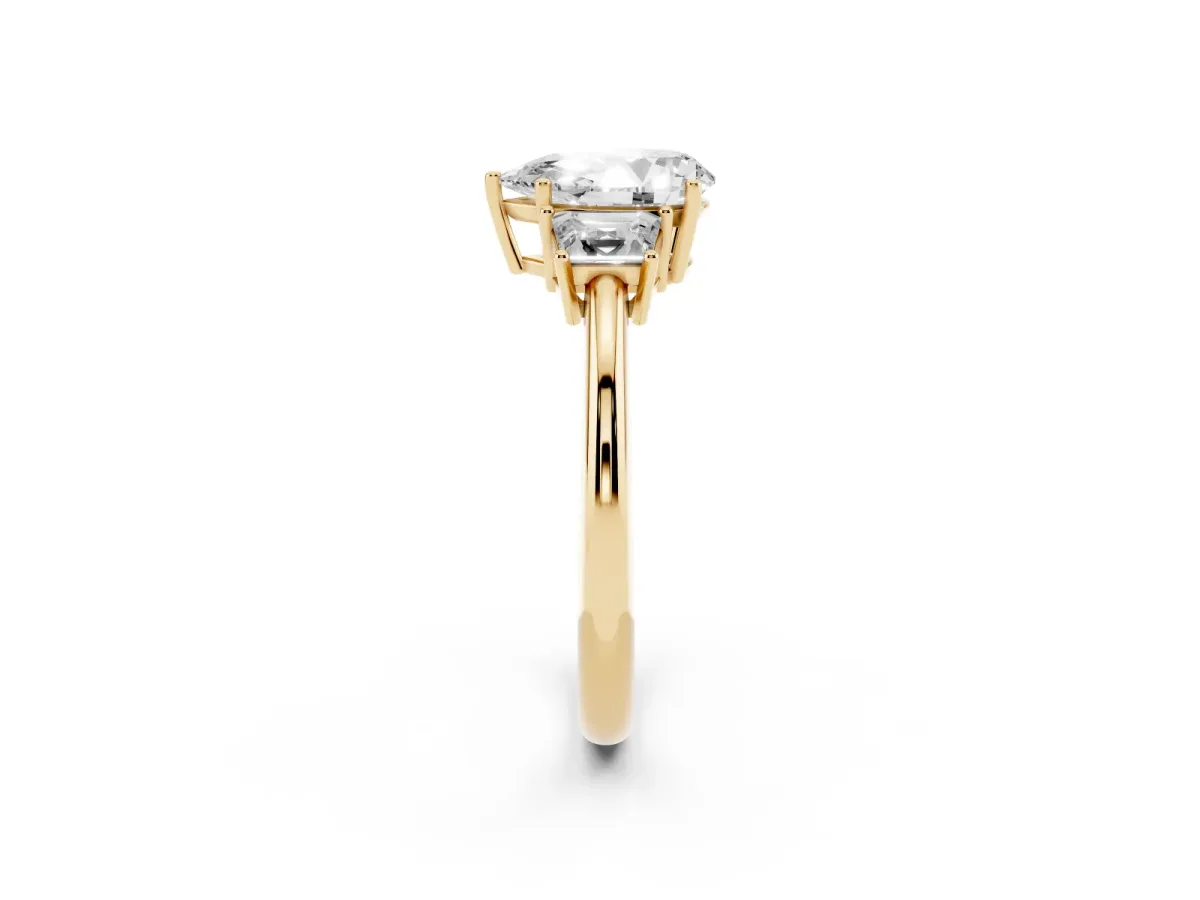 Pear Cut Diamond Three-Stone Ring with Trapezoid Side Stones and Prong Setting Yellow gold