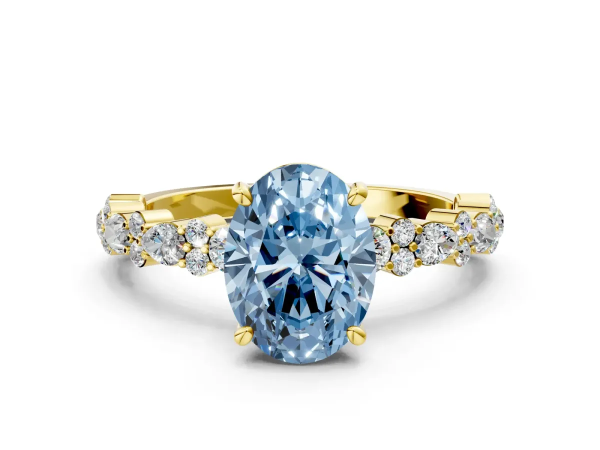 Fancy Blue Oval Cut Diamond Side Stone Solitaire Ring with Round and Four-Prong Setting Yellow gold