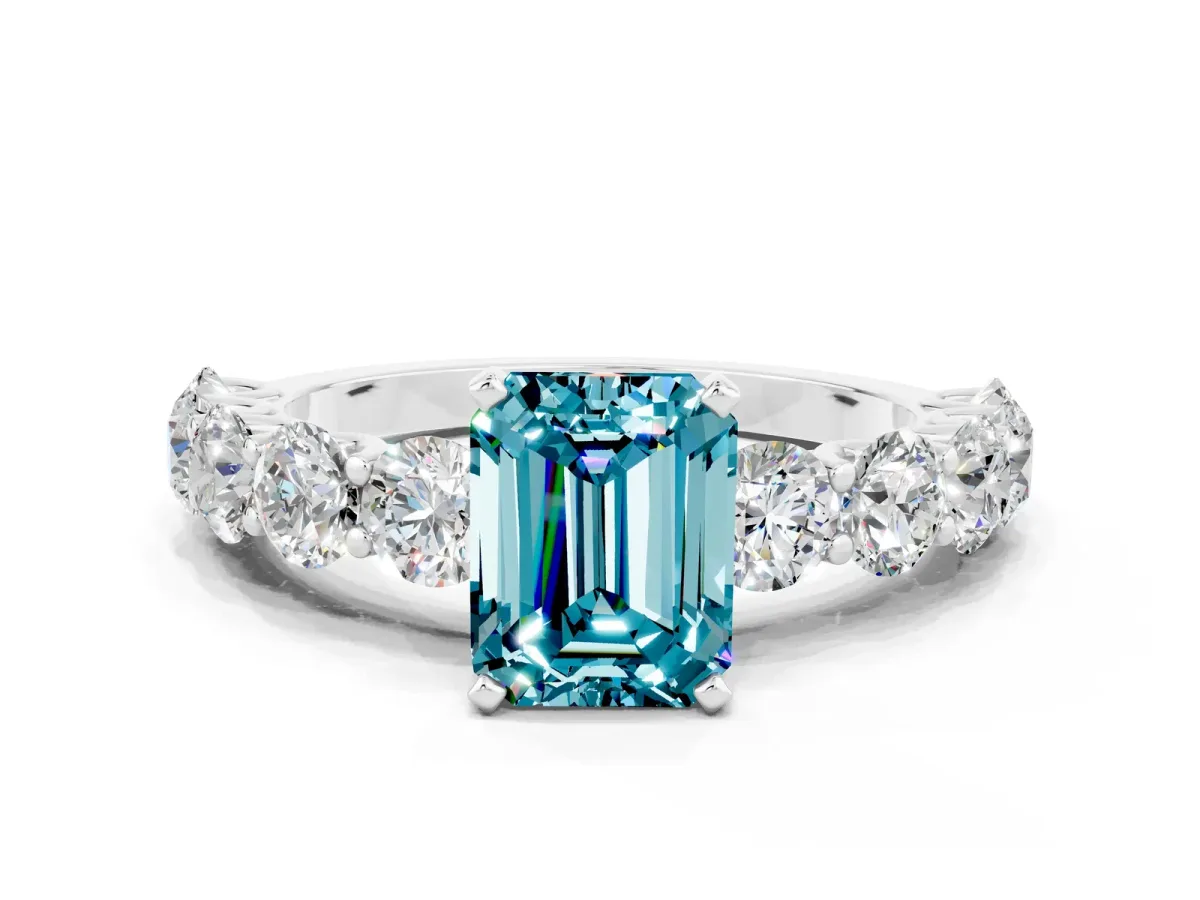 Emerald Cut Blue Topaz Prong Setting with Side Stones on a Pave Band Silver