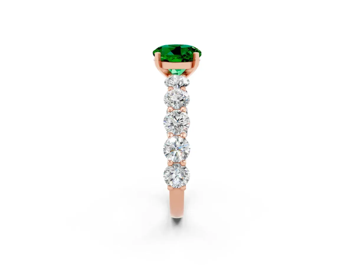 Round Cut Emerald Prong Setting with Side Stones on a Pave Band Rose gold