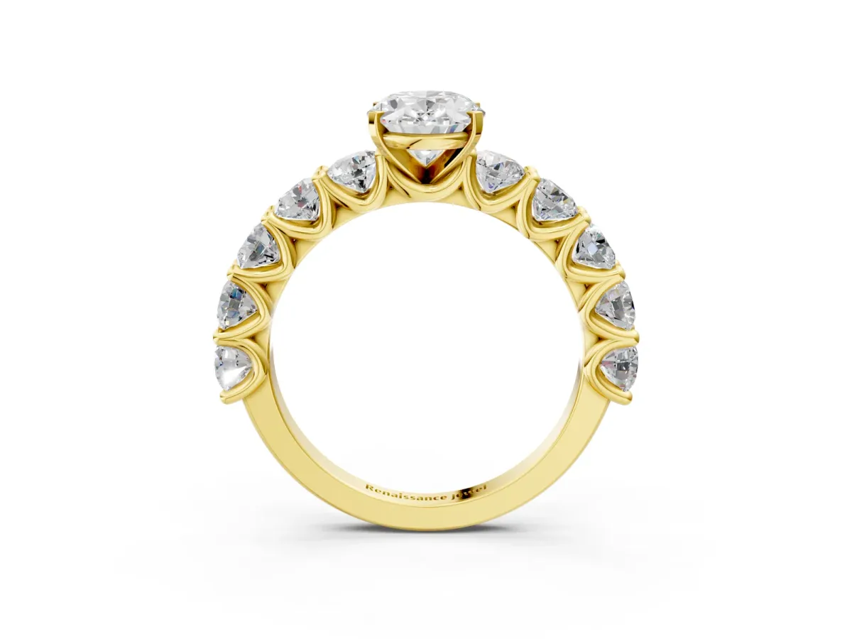 Oval Cut Diamond Prong Setting with Side Stones on a Pave Band Yellow gold