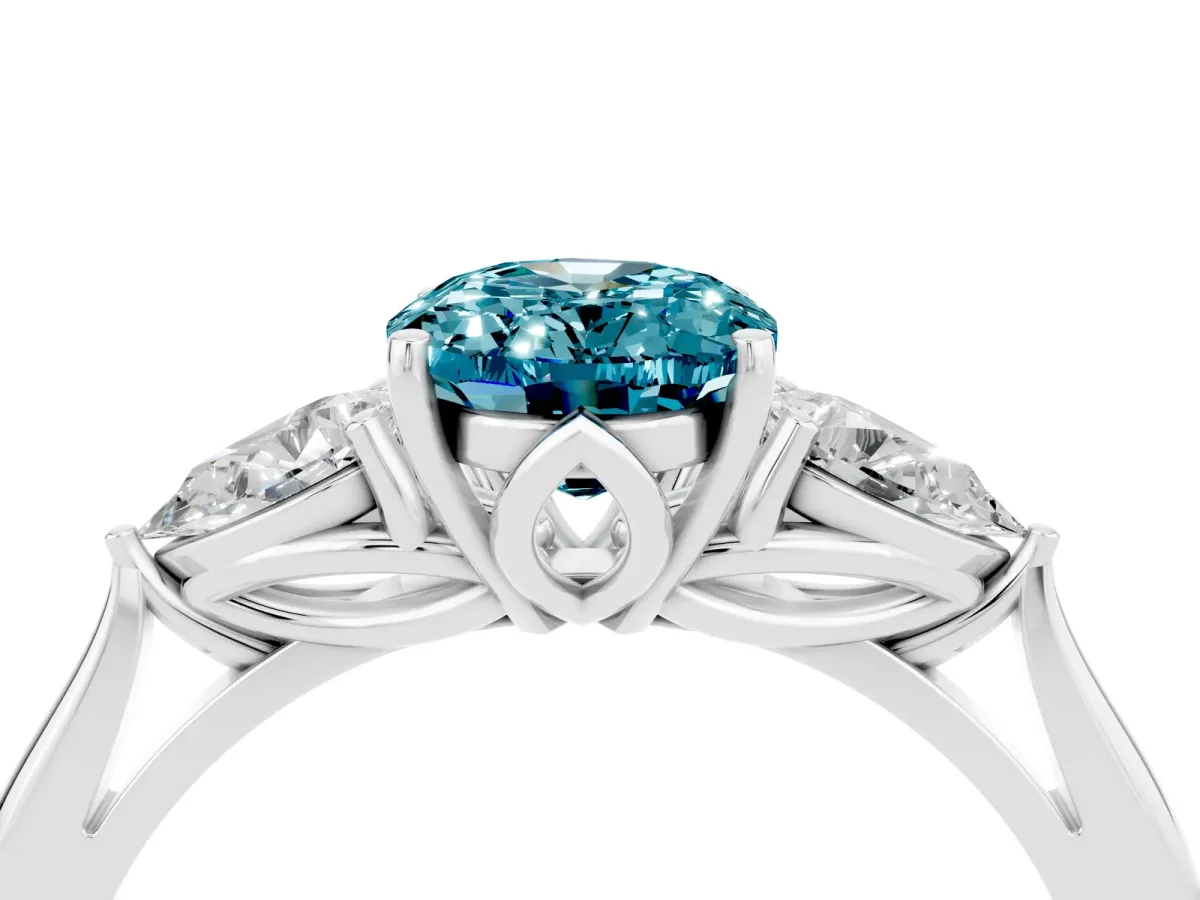 Three-Stone Oval Cut Blue Topaz Ring with Pear Side Stones in Four-Prong Setting White gold