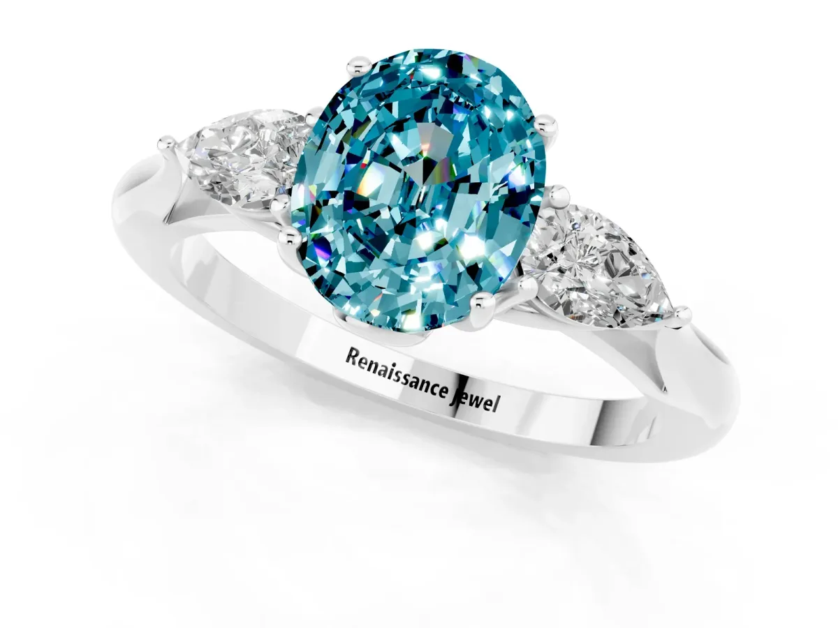 Three-Stone Oval Cut Blue Topaz Ring with Pear Side Stones in Four-Prong Setting White gold
