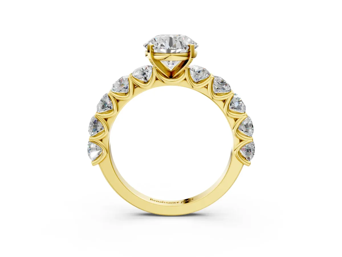 Round Cut Diamond Prong Setting with Side Stones on a Pave Band Yellow gold