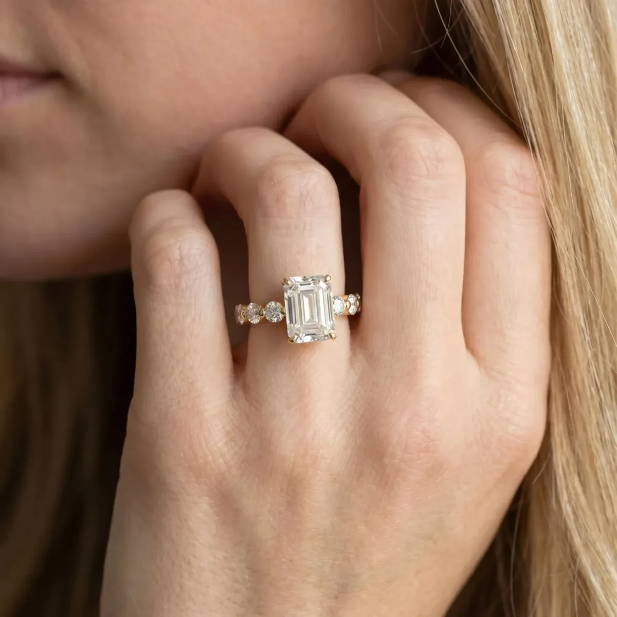 Emerald Cut Solitaire Diamond Ring with Pave Band and Four-Prong Setting Yellow gold