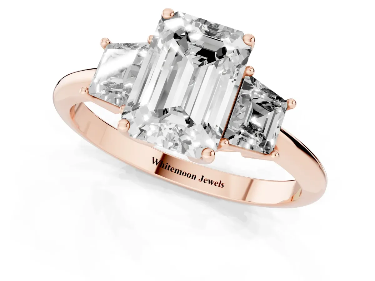 Emerald Cut Diamond Three-Stone Ring with Trapezoid Side Stones and Prong Setting Rose gold
