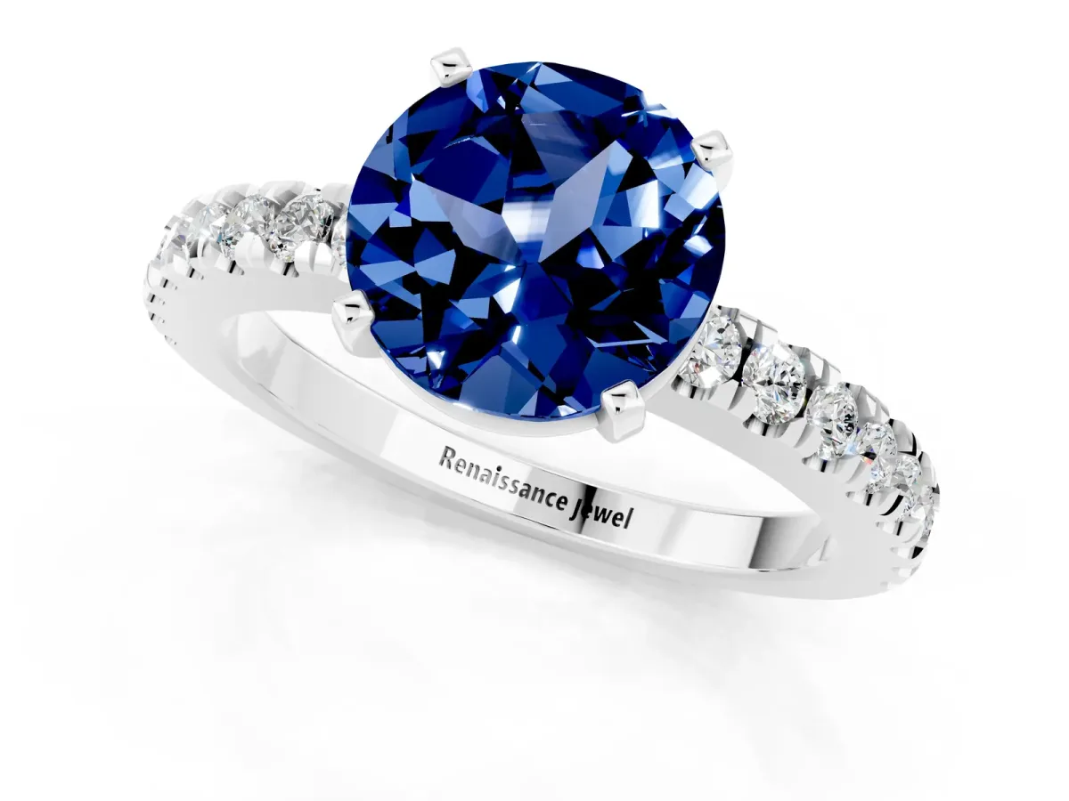 Round Cut Solitaire Blue Sapphire with Pavé Band and Four-Prong Setting Silver