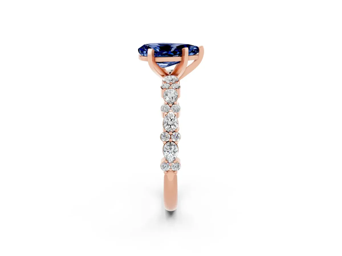 Pear Cut Blue Sapphire Side Stone Solitaire Ring with Round and Four-Prong Setting Rose gold