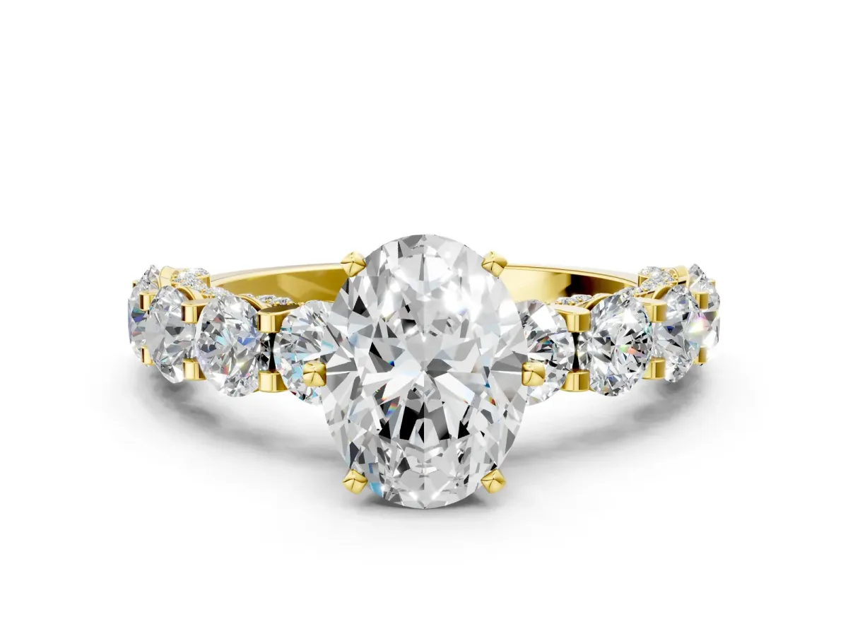 Oval Cut Diamond Side Stone Engagement Ring with Four-Prong Setting Yellow gold