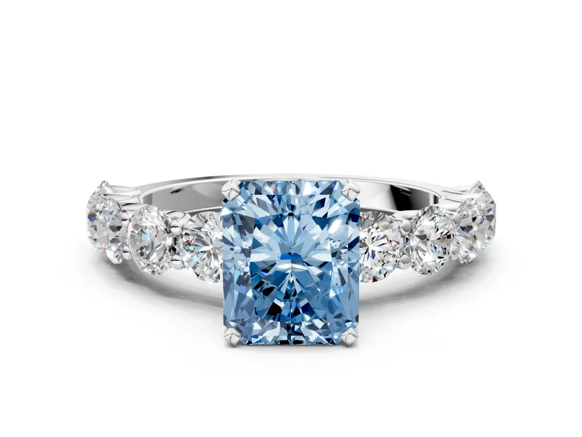 Fancy Blue Radiant Cut Diamond Prong Setting with Side Stones on a Pave Band Silver