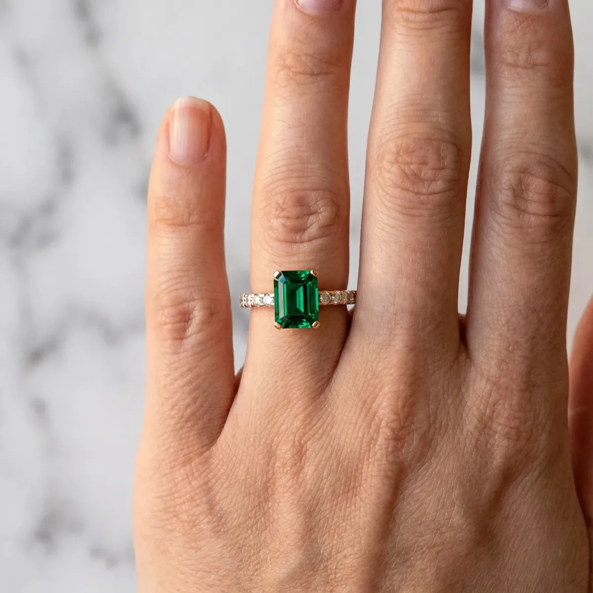 Emerald Cut Emerald Solitaire Ring with Round Pavé Band and Four-Prong Setting Rose gold