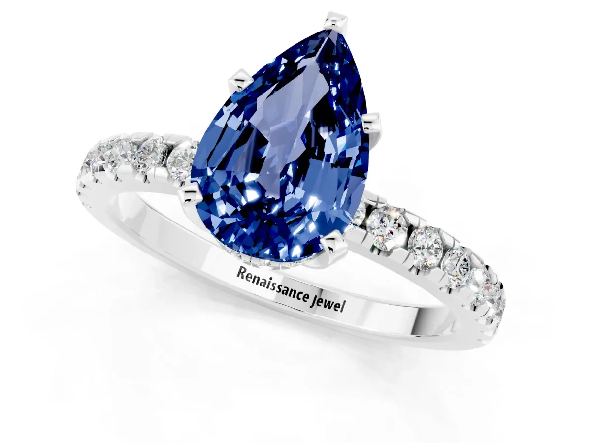 Pear Cut Blue Sapphire Solitaire Ring with Round Pavé Band and Four-Prong Setting Silver