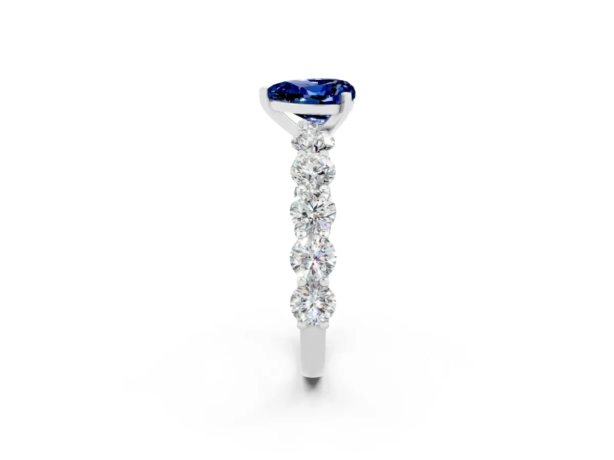 Heart Cut Blue Sapphire Prong Setting with Side Stones on a Pave Band Silver