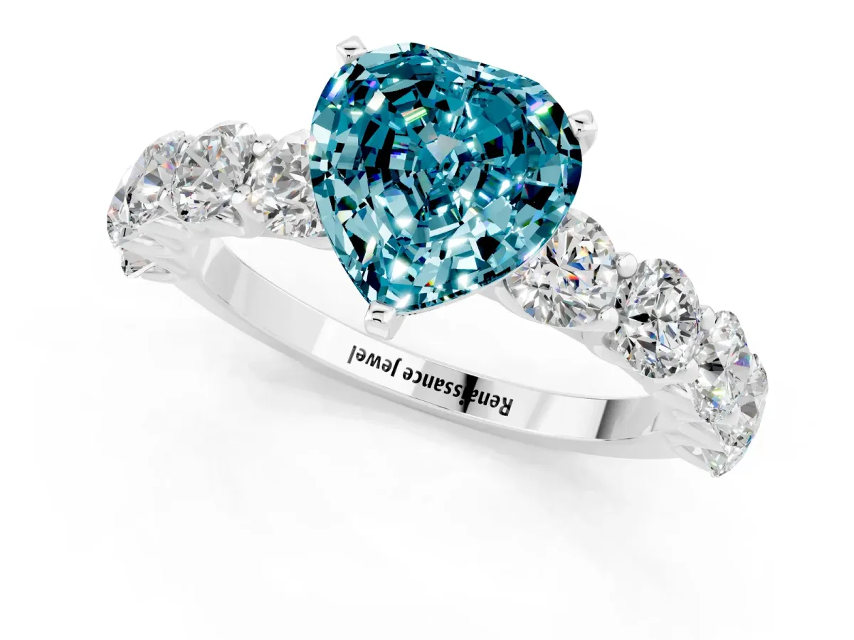 Heart Cut Blue Topaz Prong Setting with Side Stones on a Pave Band Silver