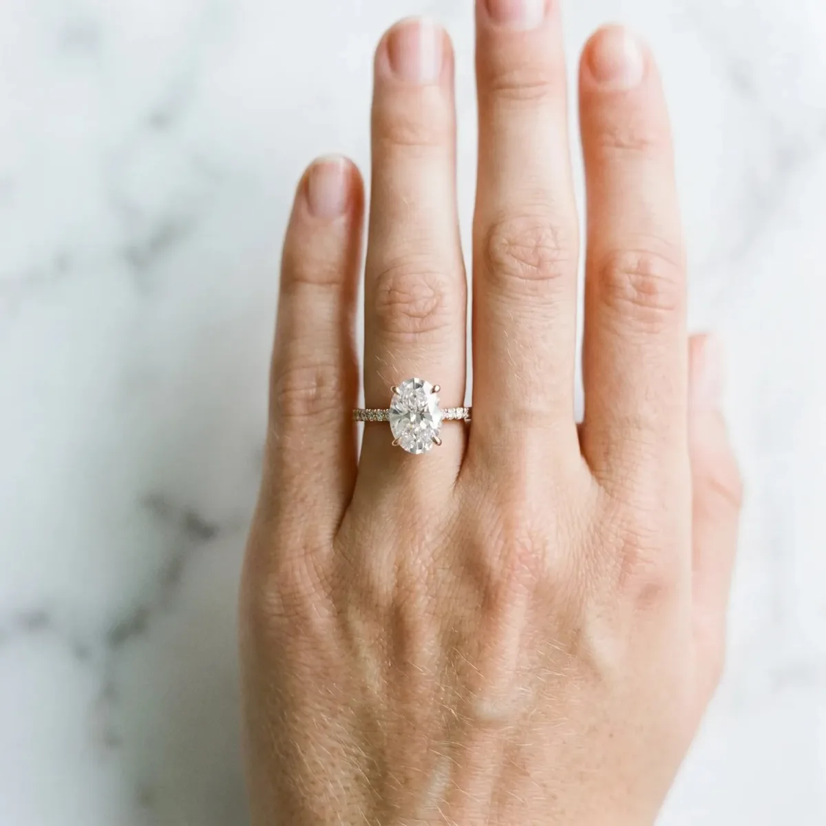 Oval Cut Diamond Solitaire Ring with Round Pavé Band and Prong Setting Rose gold
