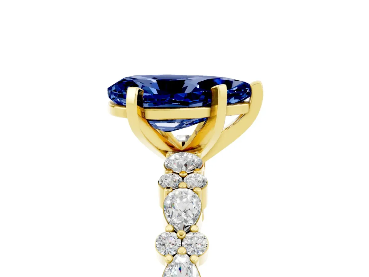Pear Cut Blue Sapphire Side Stone Solitaire Ring with Round and Four-Prong Setting Yellow gold