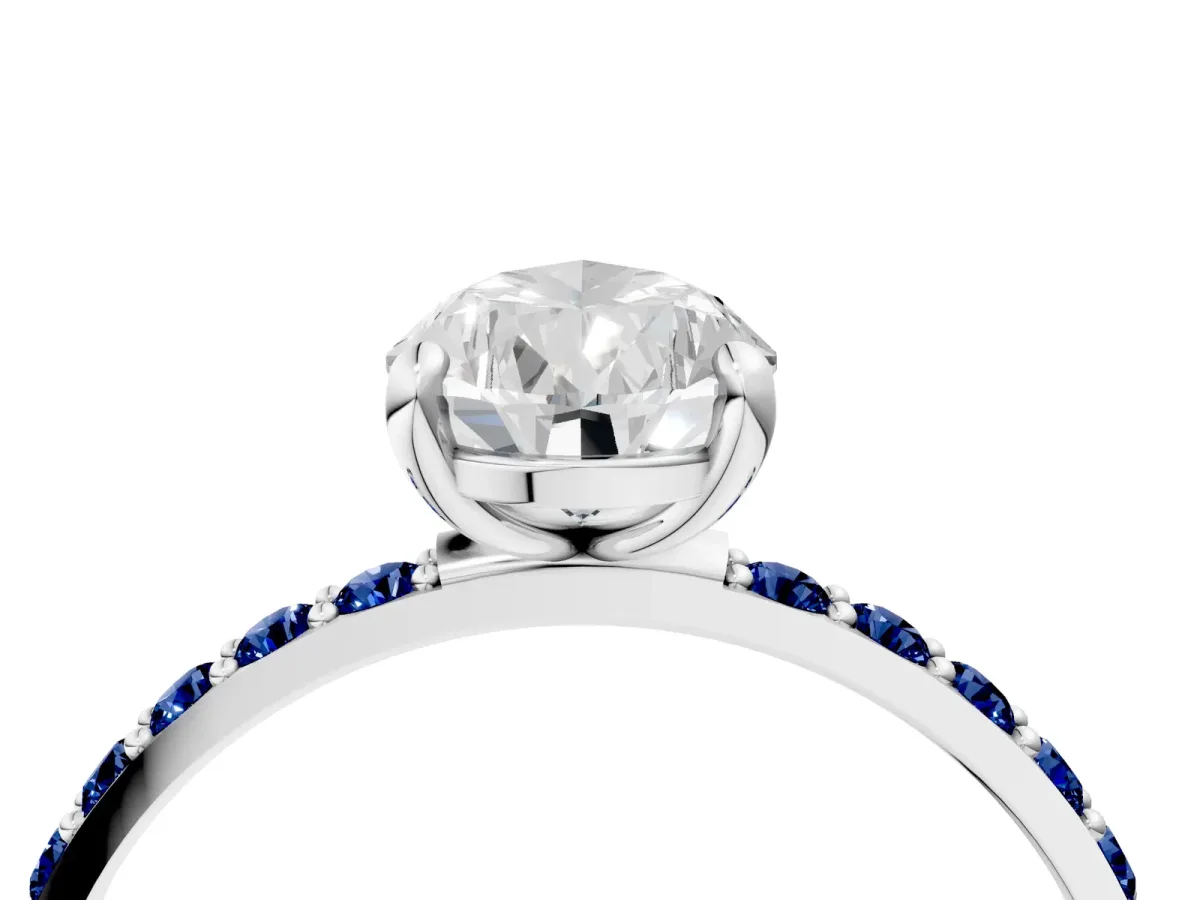 Pear Cut Diamond Solitaire Ring with Round Blue Sapphire Pavé Band and Prong Setting Silver