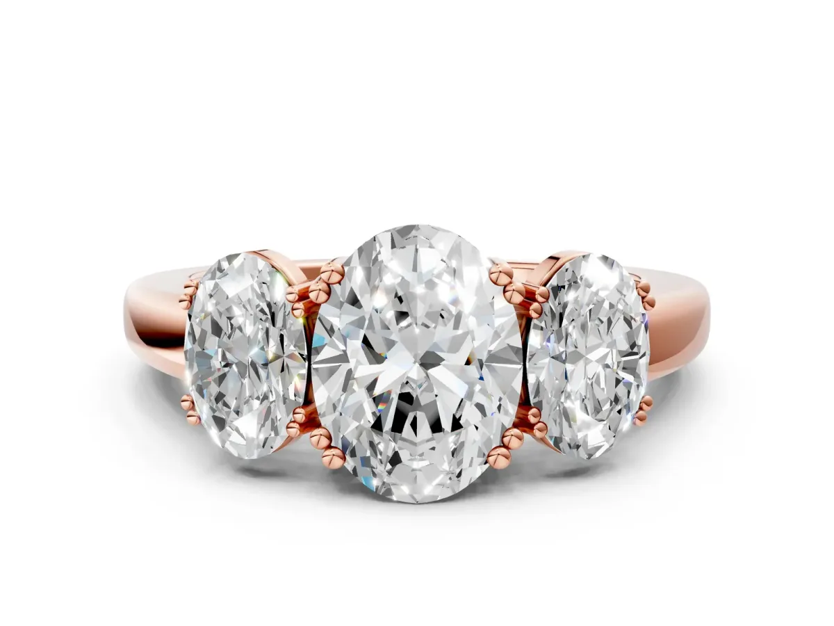 Three-Stone Oval Cut Cut Diamond Ring with Channel Set Band and Four-Prong Setting Rose gold