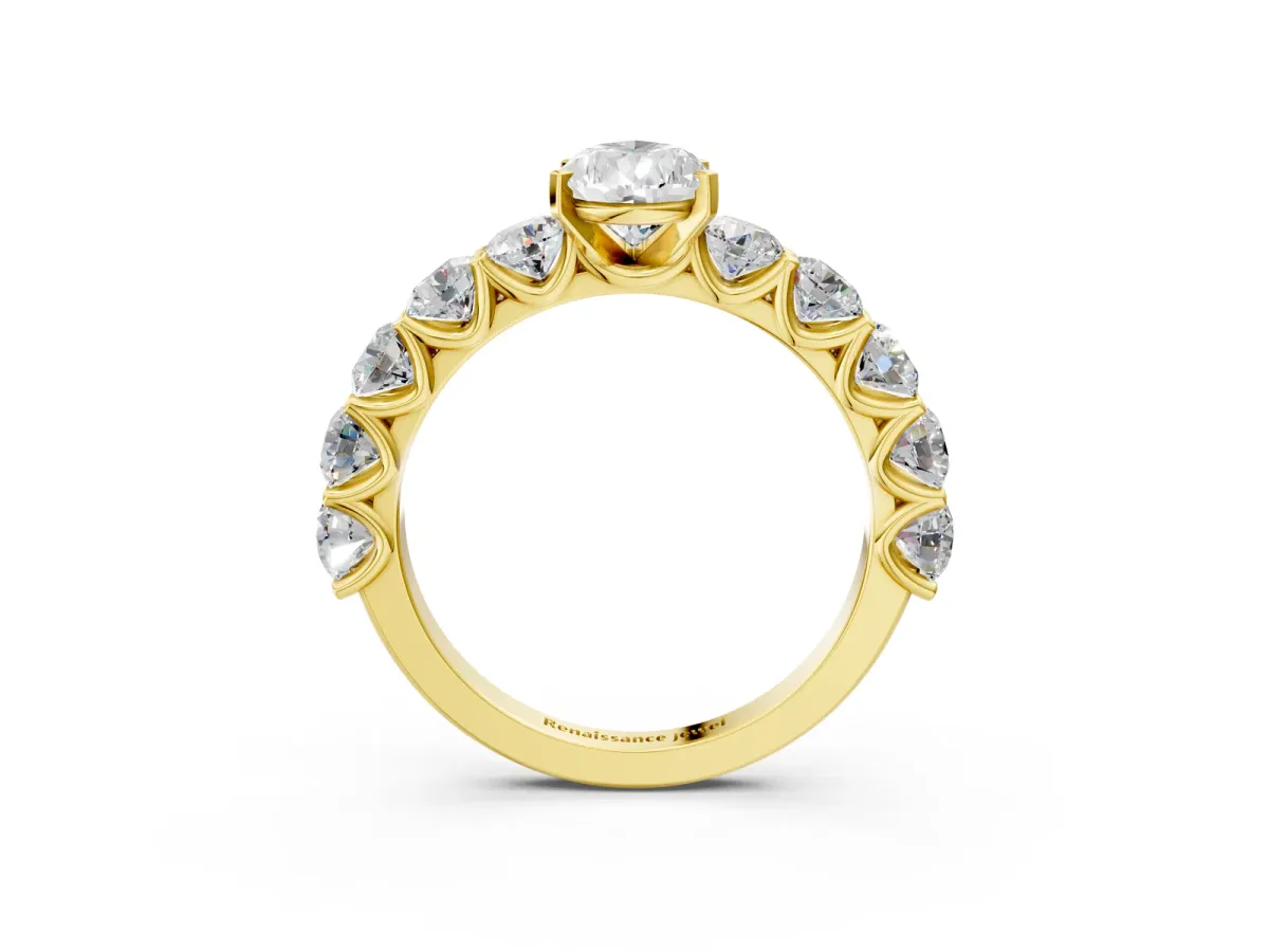 Pear Cut Diamond Prong Setting with Side Stones on a Pave Band Yellow gold