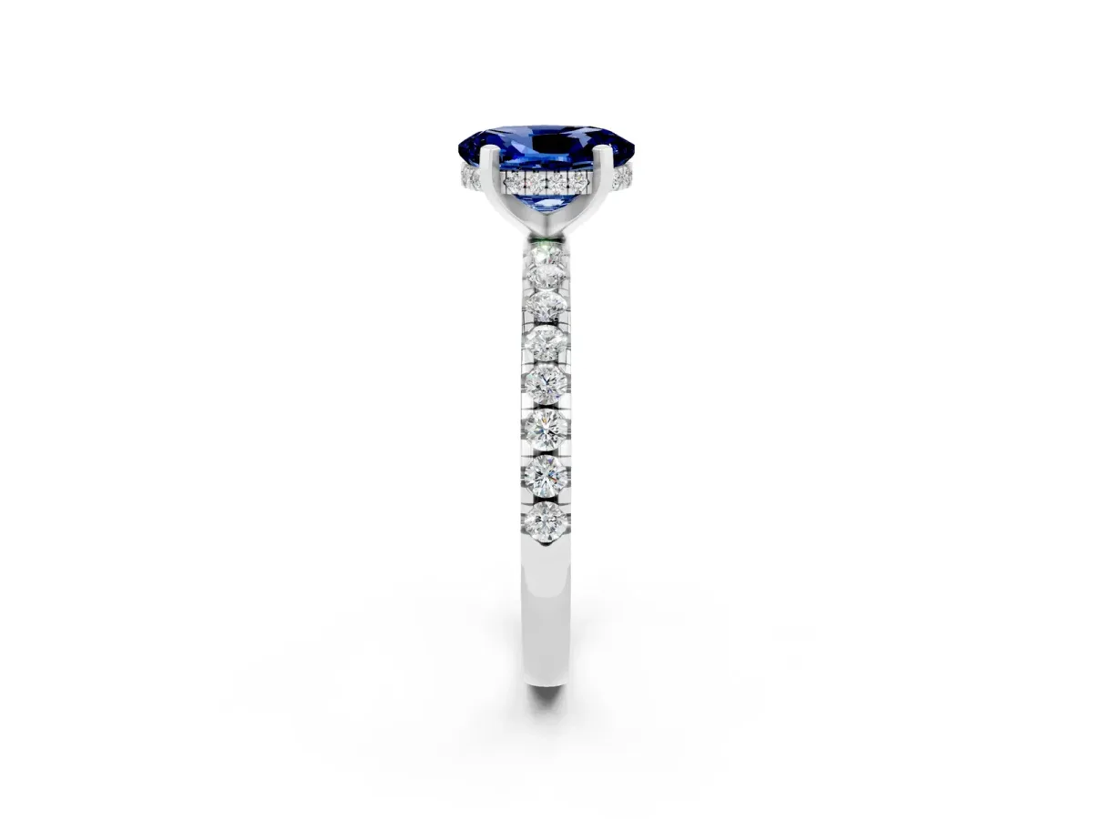 Oval Cut Blue Sapphire Solitaire Ring with Round Pavé Band and Four-Prong Setting Silver