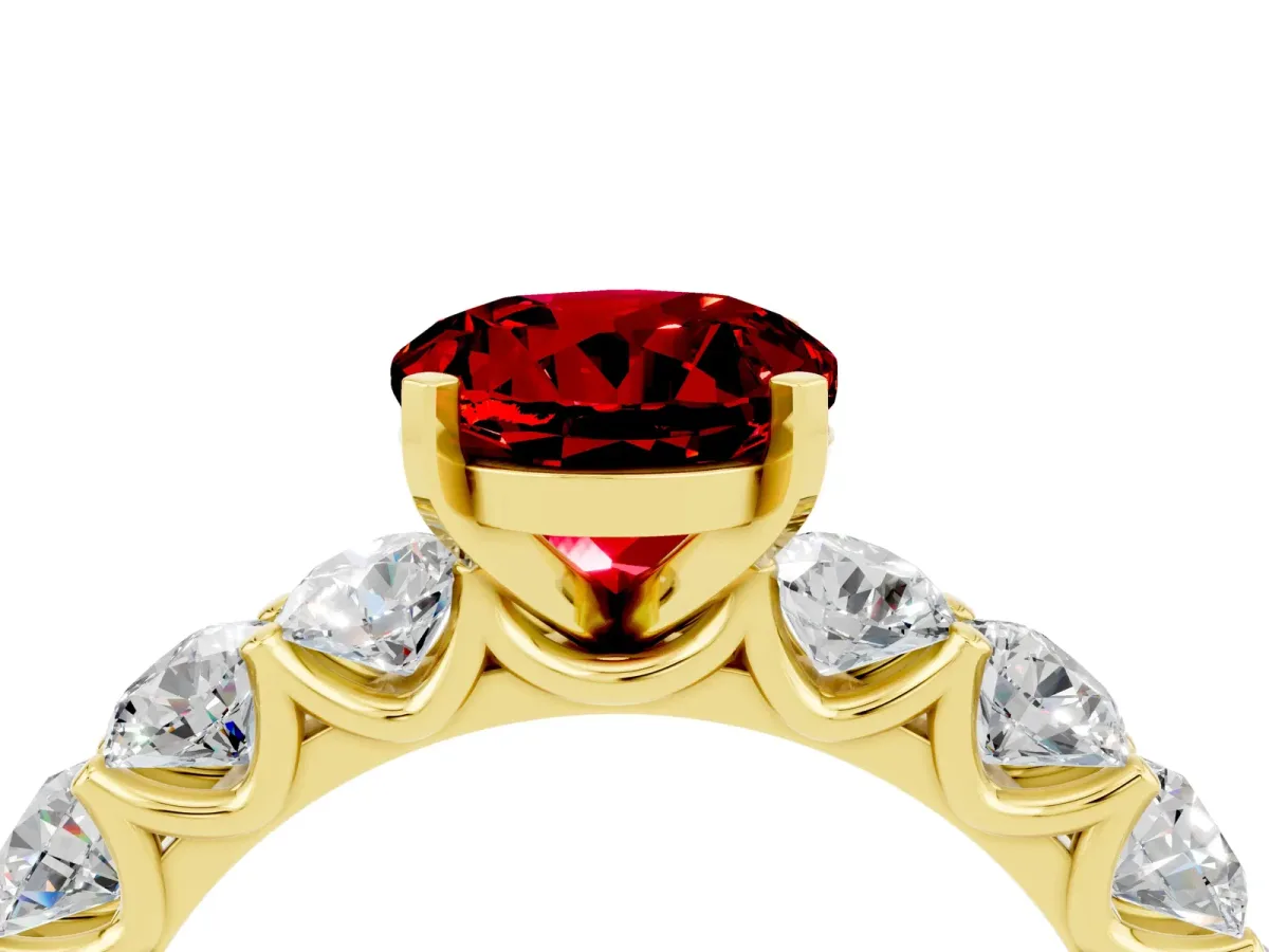 Round Cut Ruby Prong Setting with Side Stones on a Pave Band Yellow gold