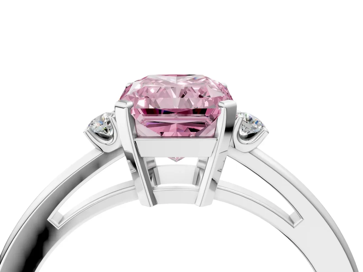 Fancy Pink Radiant Cut Cut Three-Stone Solitaire Ring with Round Accent Diamonds and Four-Prong Setting Platinum