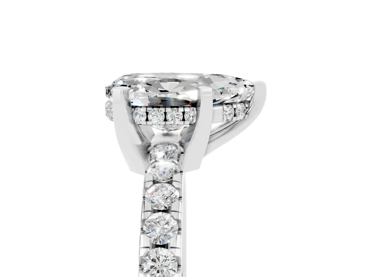 Pear Cut Moissanite Solitaire Ring with Round Pavé Band and Four-Prong Setting Silver