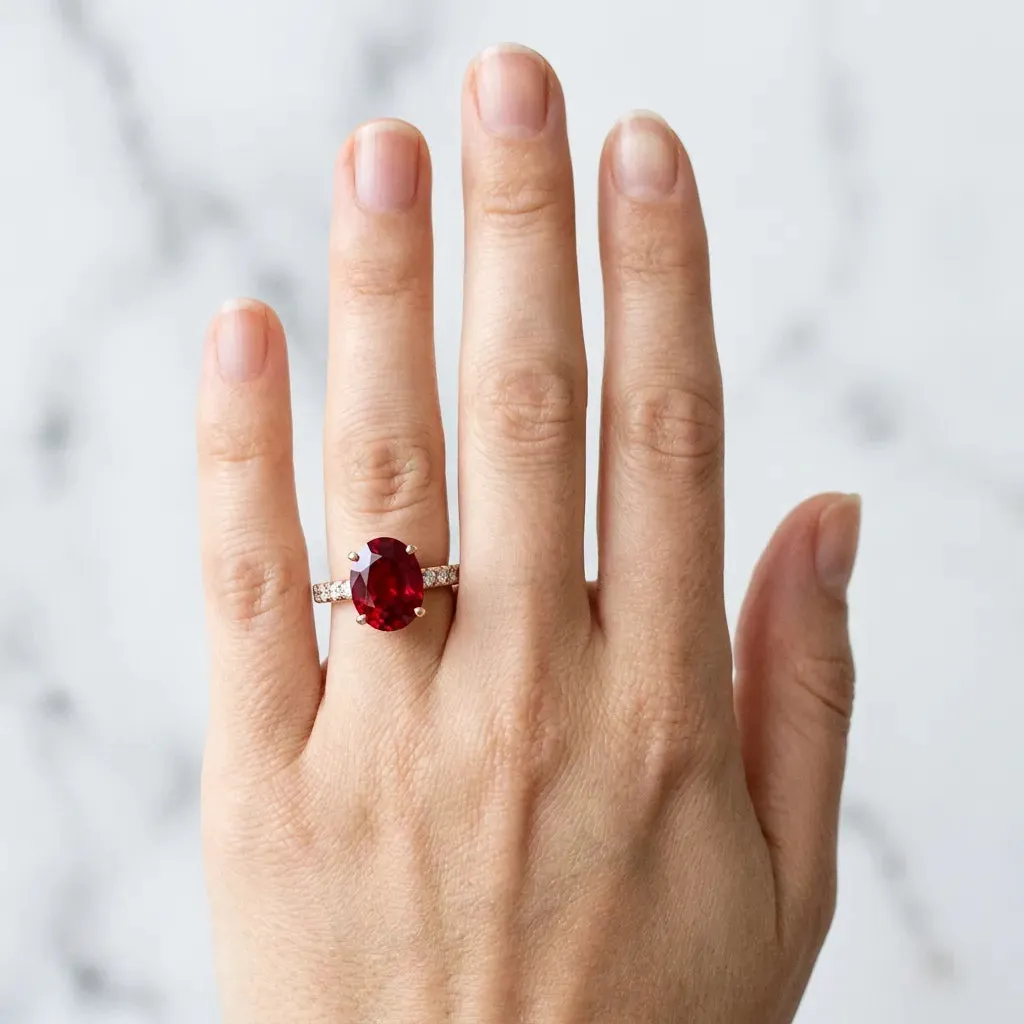 Oval Cut Ruby Solitaire Ring with Round Pavé Band and Four-Prong Setting Rose gold