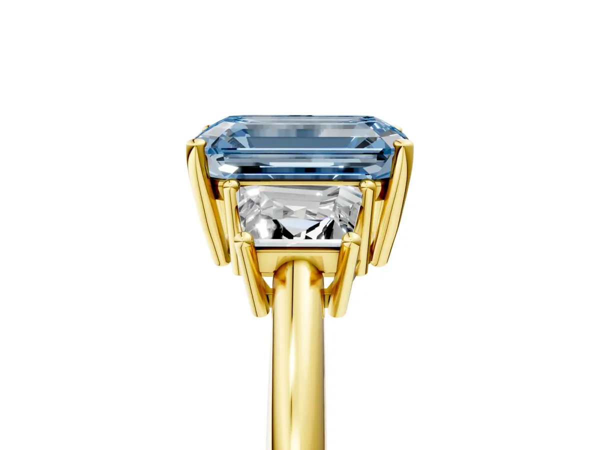 Fancy Blue Emerald Cut Diamond Three-Stone Ring with Trapezoid Side Stones and Prong Setting Yellow gold
