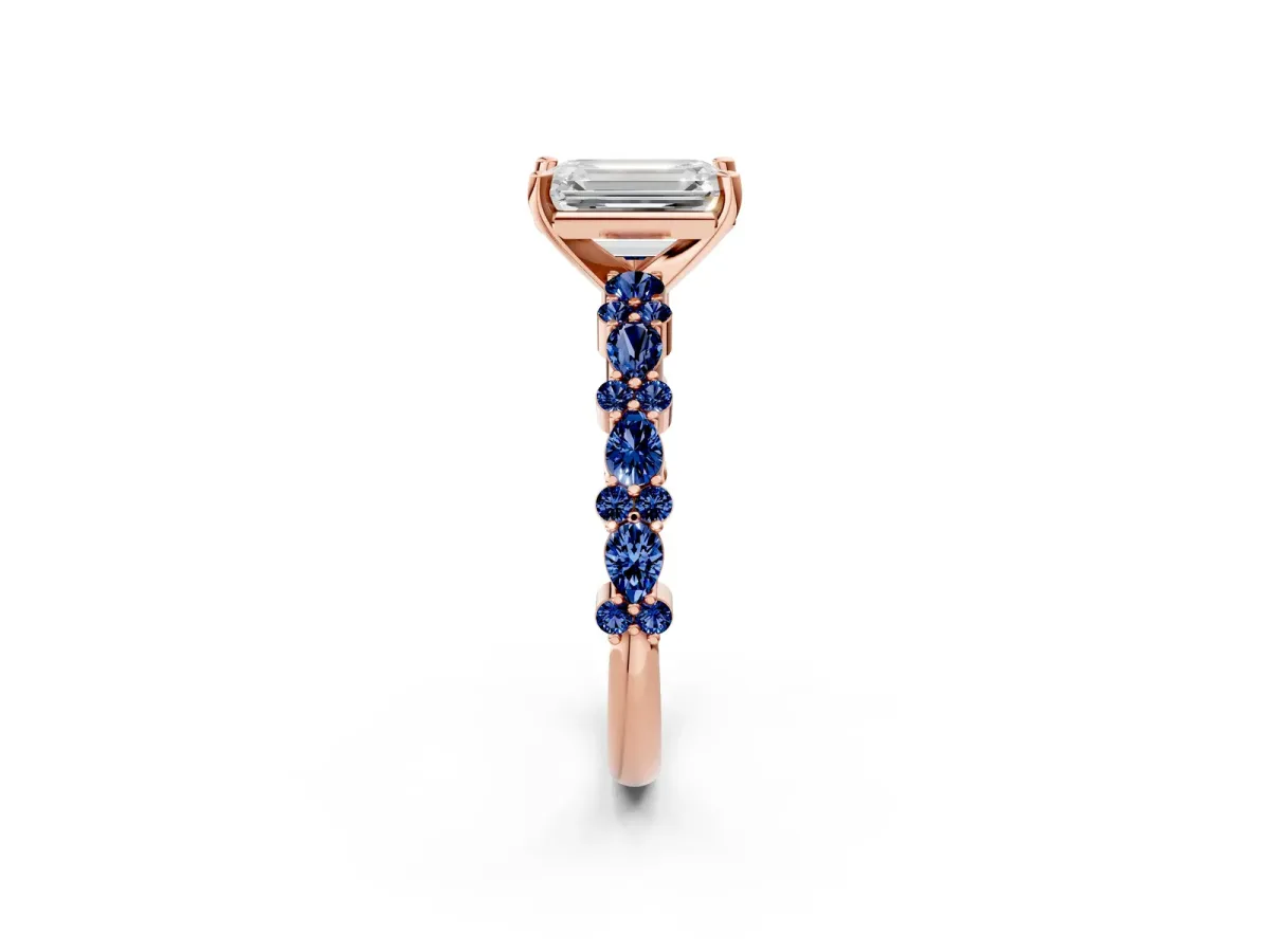 Emerald Cut Diamond Side Stone Solitaire Ring with Round Blue Sapphire and Four-Prong Setting Rose gold