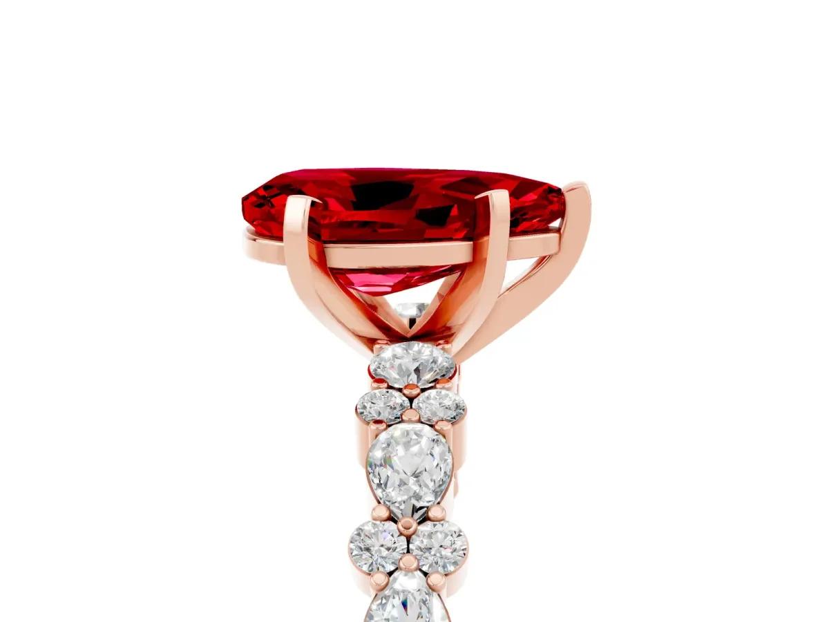 Pear Cut Ruby Side Stone Solitaire Ring with Round and Four-Prong Setting Rose gold