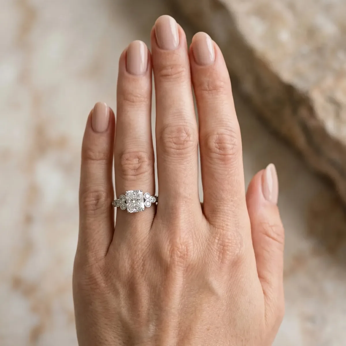 Radiant Cut Cut Diamond Engagement Ring with Bezel Set Round Side Stones and Prong Setting Platinum