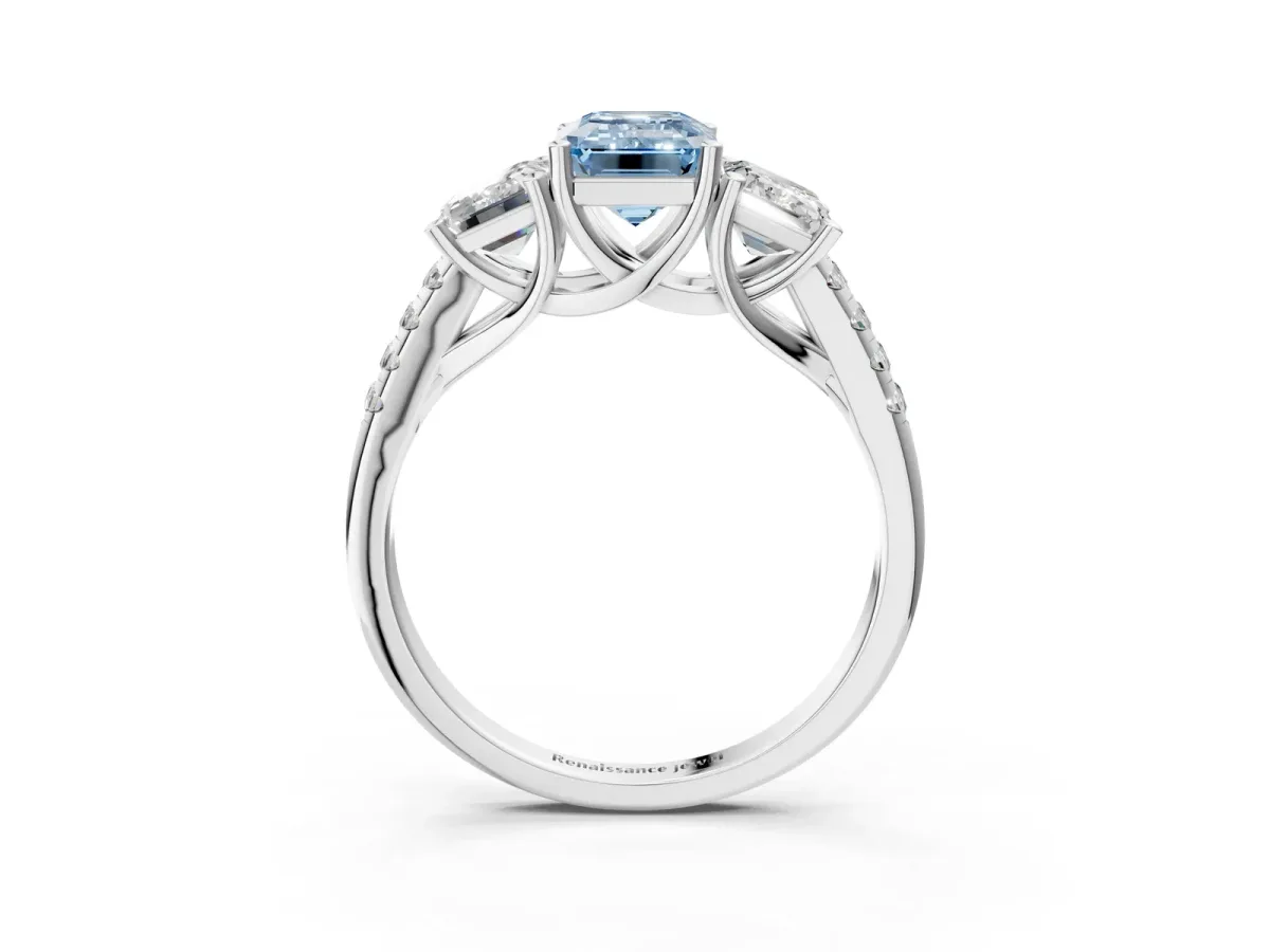Fancy Blue Three-Stone Emerald Cut Diamond Ring with Round Pavé Band and Prong Setting Platinum