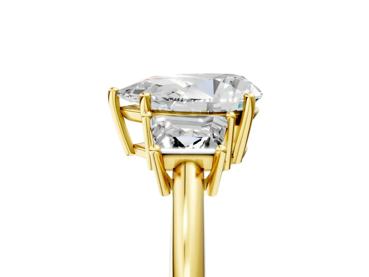 Pear Cut Diamond Three-Stone Ring with Trapezoid Side Stones and Prong Setting Yellow gold