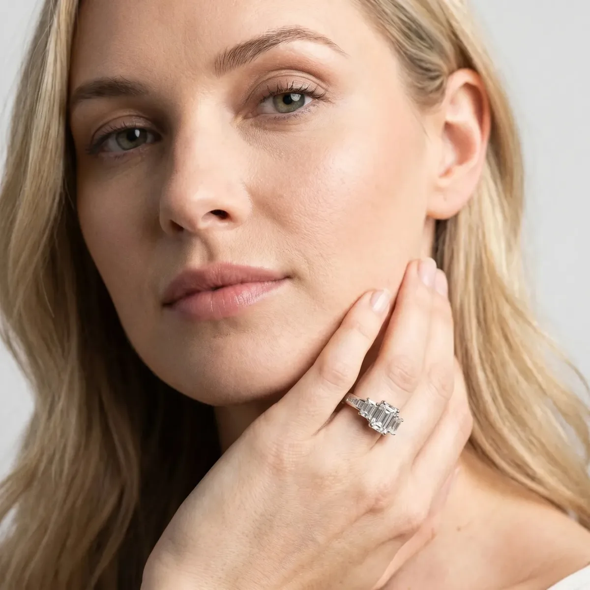 Three-Stone Emerald Cut Cut Diamond Ring with Channel Set Band and Four-Prong Setting Platinum