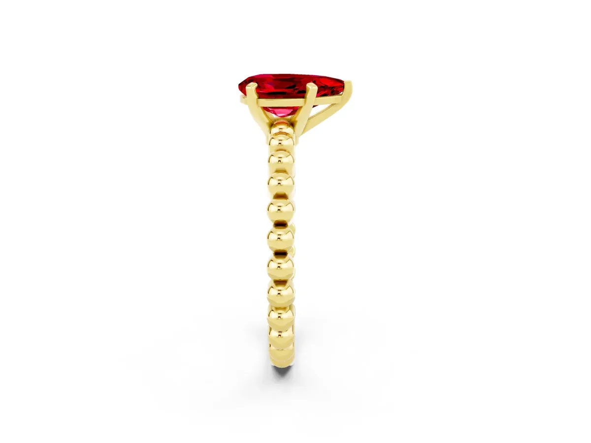 Pear Cut Ruby Solitaire Ring with Beaded Band and Prong Setting Yellow gold