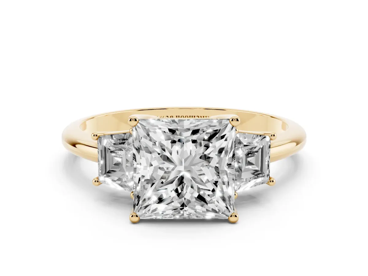 Princess Cut Diamond Three-Stone Ring with Trapezoid Side Stones and Prong Setting Yellow gold