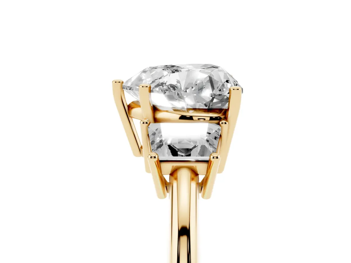 Heart Cut Diamond Three-Stone Ring with Trapezoid Side Stones and Prong Setting Yellow gold