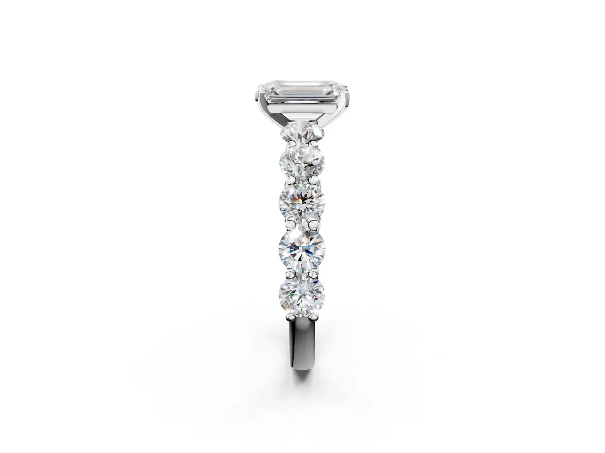 Emerald Cut Diamond Prong Setting with Side Stones on a Pave Band Platinum