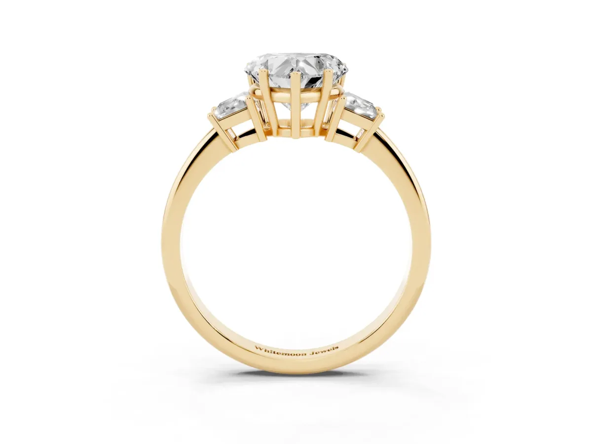 Heart Cut Diamond Three-Stone Ring with Trapezoid Side Stones and Prong Setting Yellow gold