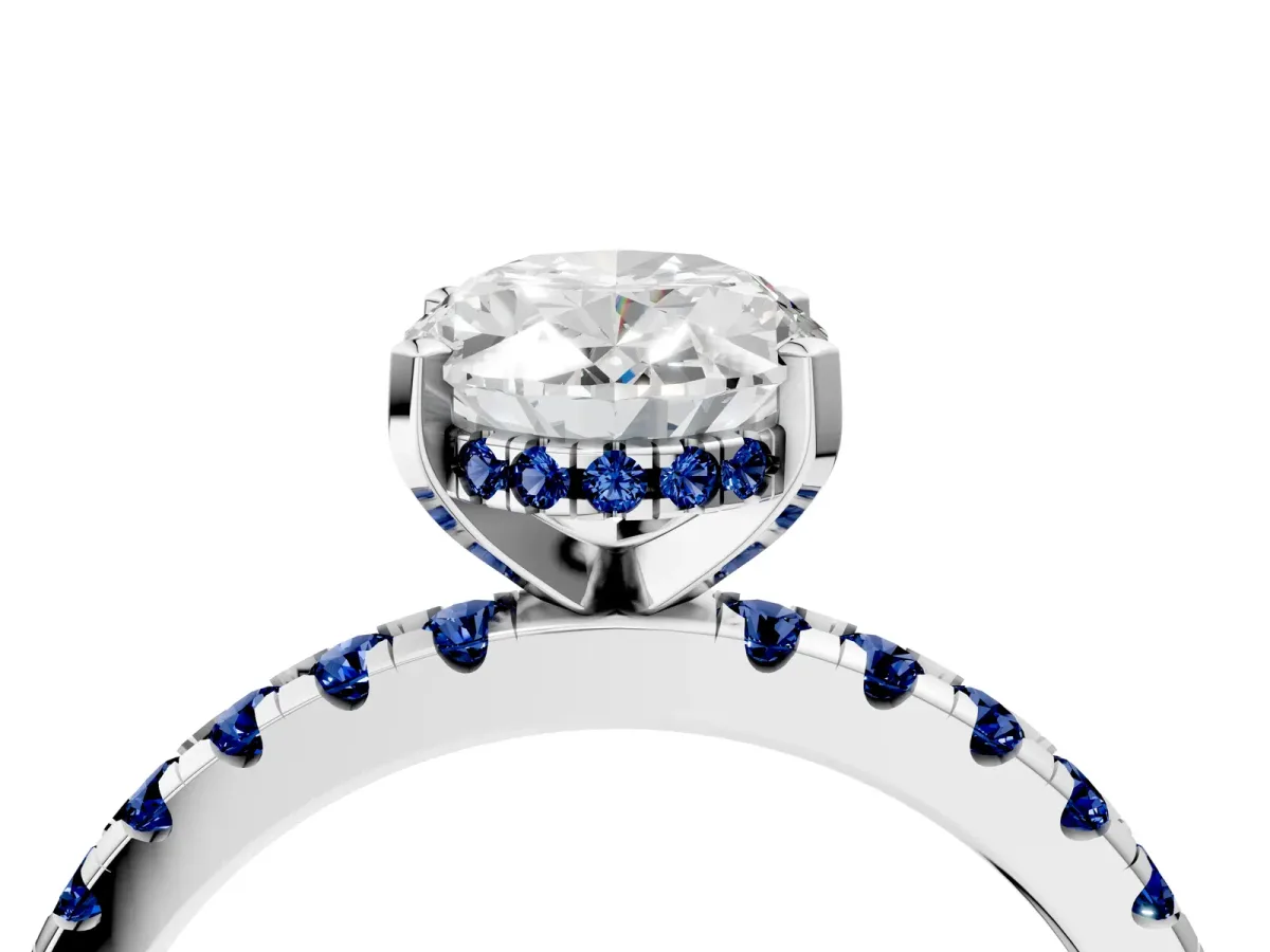 Oval Cut Diamond Solitaire Ring with Round Blue Sapphire Pavé Band and Four-Prong Setting Silver
