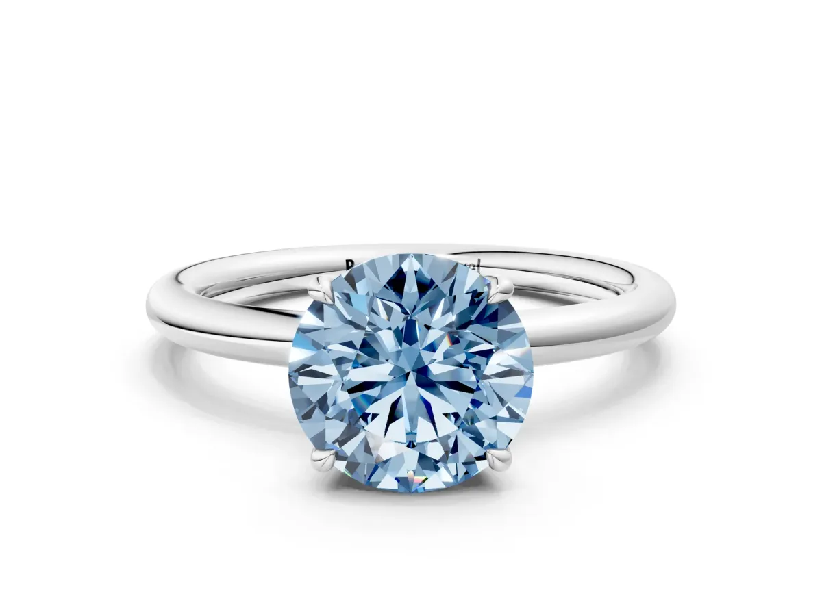 Fancy Blue Round Cut Diamond Solitaire Ring with Thin Band and Four-Prong Setting Silver