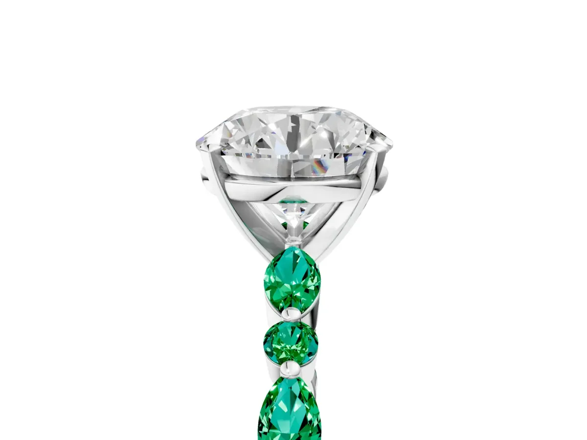 Round Cut Diamond Ring with Marquise and Round Emerald Side Stones and Four-Prong Setting Silver