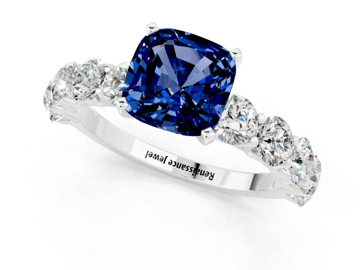 Cushion Cut Blue Sapphire Prong Setting with Side Stones on a Pave Band Silver