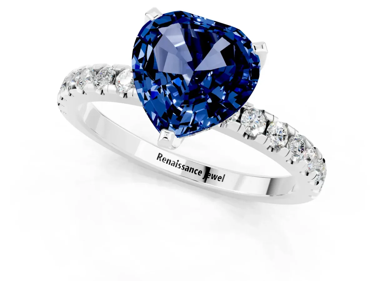Heart Cut Blue Sapphire Solitaire Ring with Round Pavé Band and Four-Prong Setting Silver