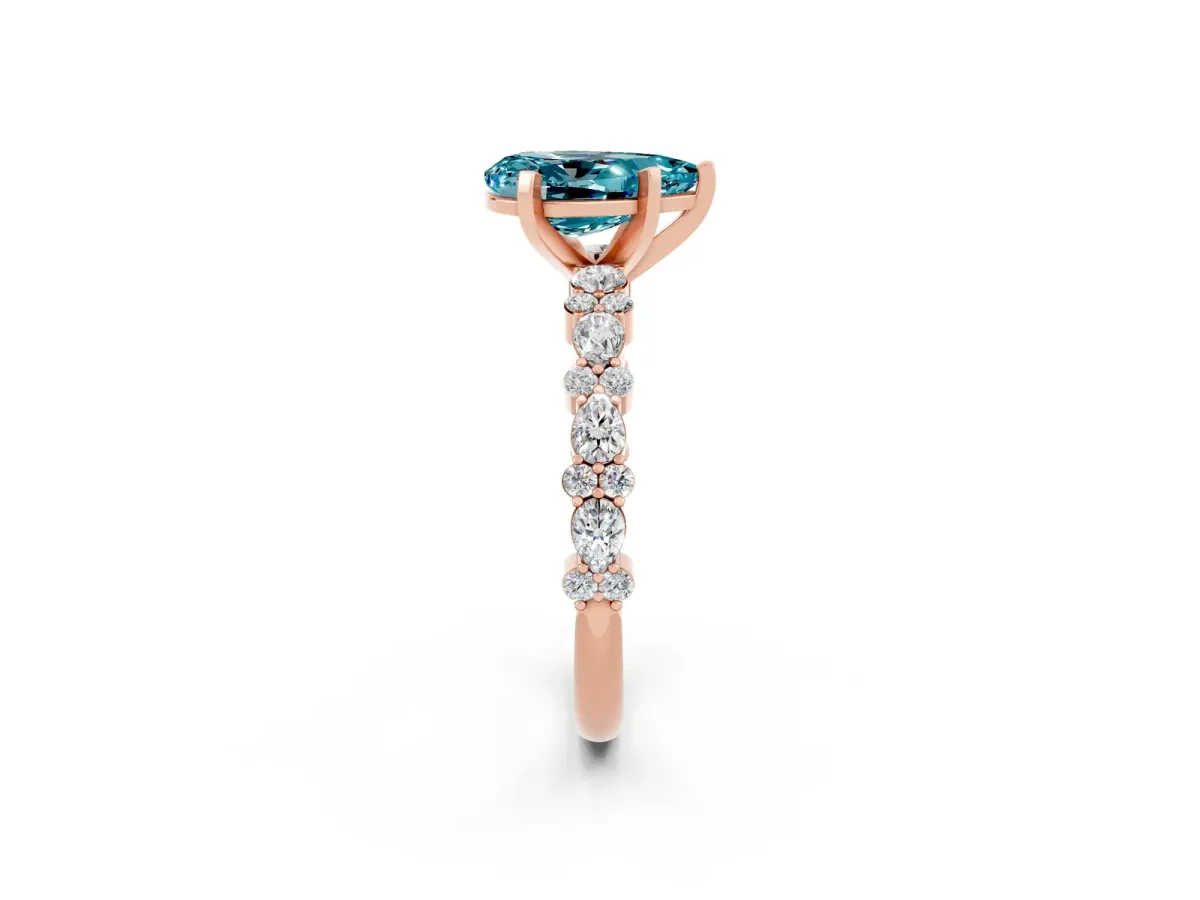 Pear Cut Blue Topaz Side Stone Solitaire Ring with Round and Four-Prong Setting Rose gold