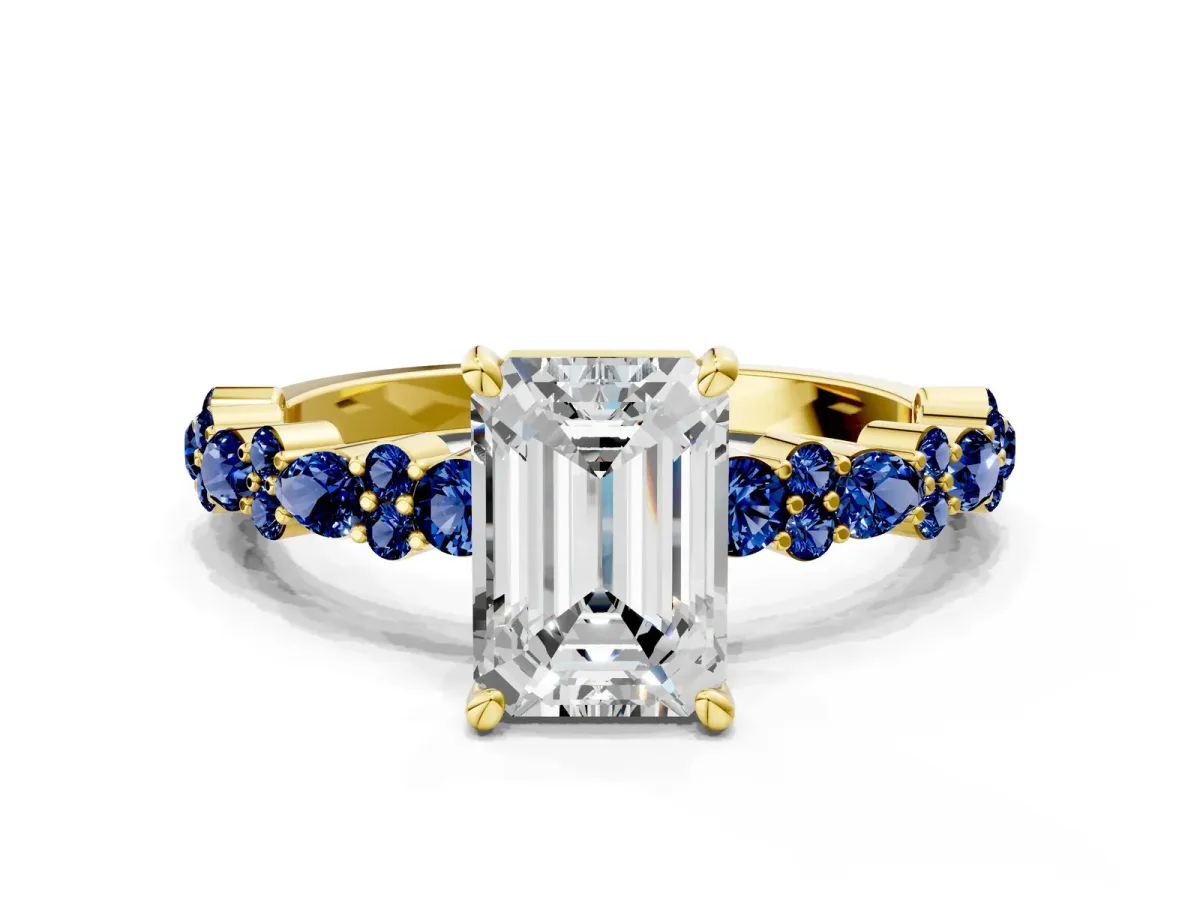 Emerald Cut Diamond Side Stone Solitaire Ring with Round Blue Sapphire and Four-Prong Setting Yellow gold