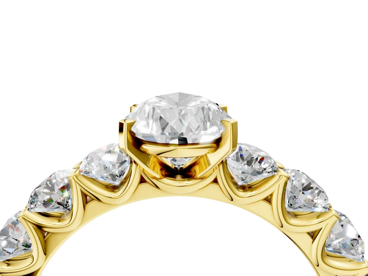 Pear Cut Diamond Prong Setting with Side Stones on a Pave Band Yellow gold